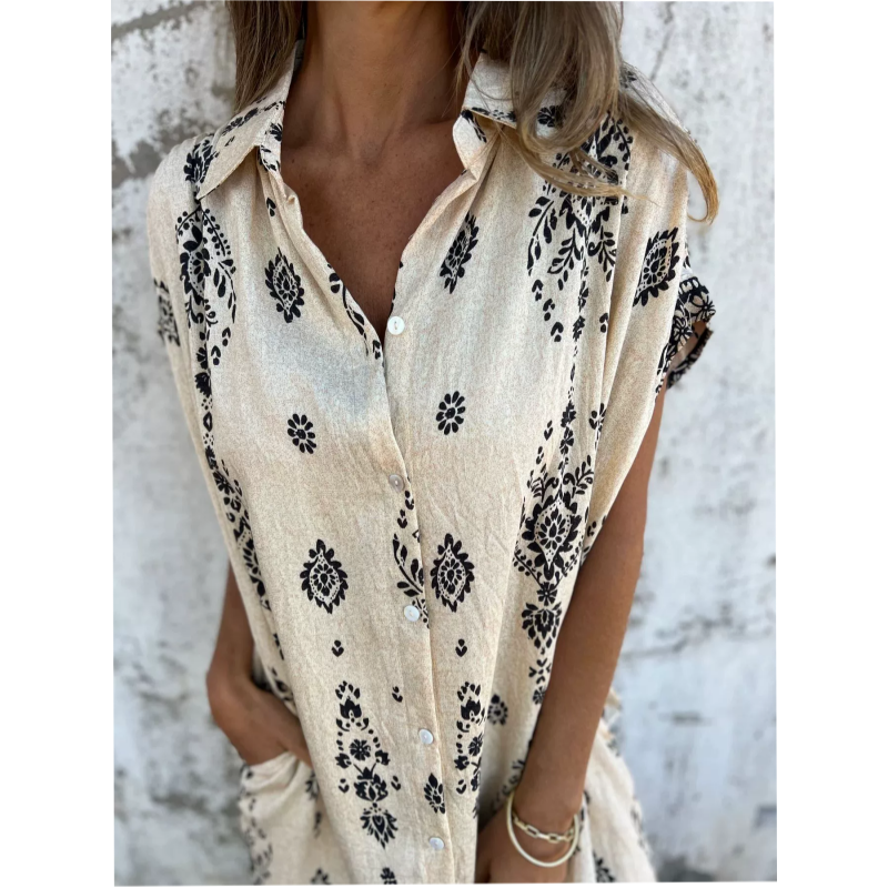 Woman wearing the Isabelle vintage print shirt dress with a button front and soft collar, standing in warm daylight.