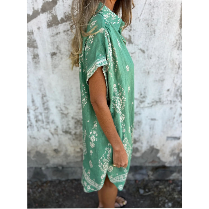 Woman wearing the Isabelle vintage print shirt dress with a button front and soft collar, standing in warm daylight.