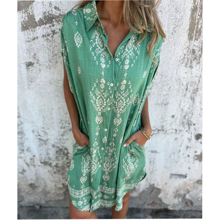 Woman wearing the Isabelle vintage print shirt dress with a button front and soft collar, standing in warm daylight.