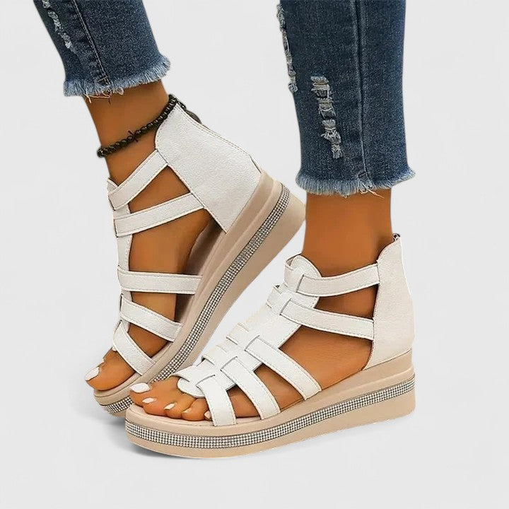 A woman in black strappy sandals walking confidently on a summer day, feet relaxed and supported.