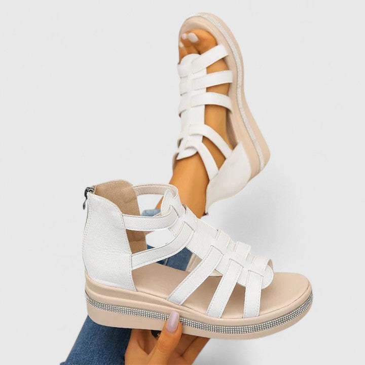 A woman in black strappy sandals walking confidently on a summer day, feet relaxed and supported.