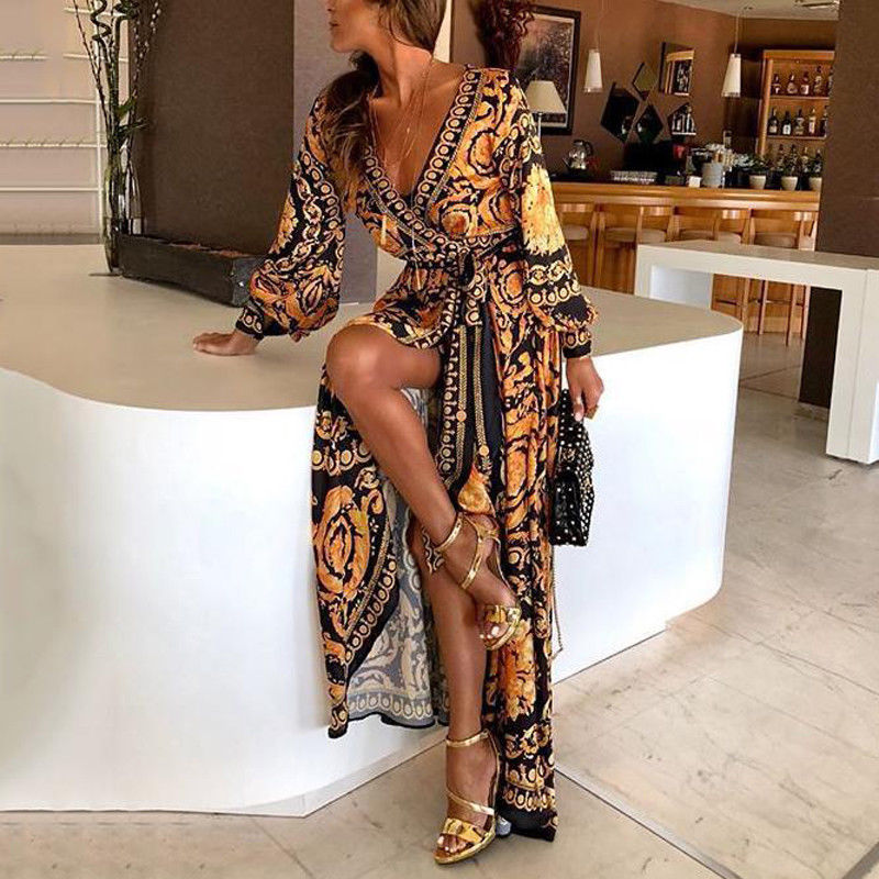 Woman at golden hour wearing the Eileen vintage print maxi dress with a waist belt and long statement sleeves.
