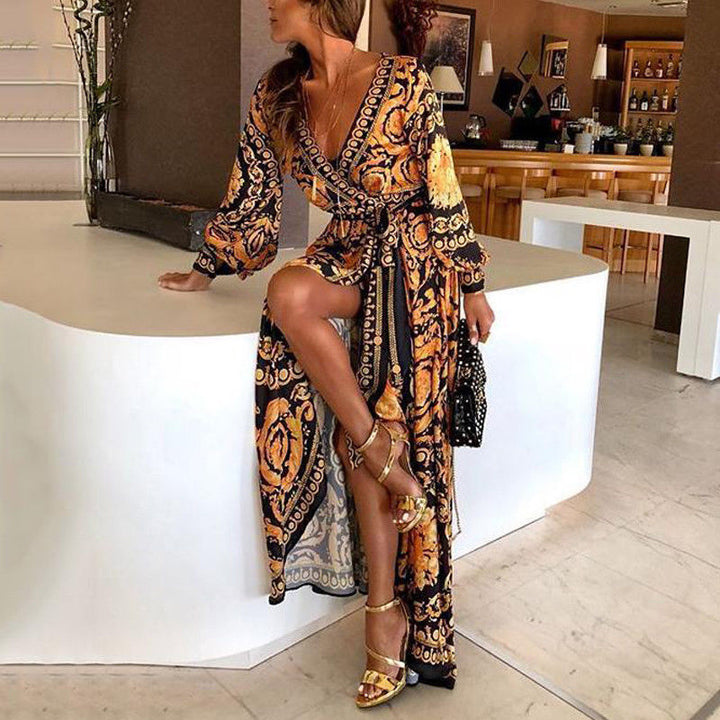 Woman at golden hour wearing the Eileen vintage print maxi dress with a waist belt and long statement sleeves.