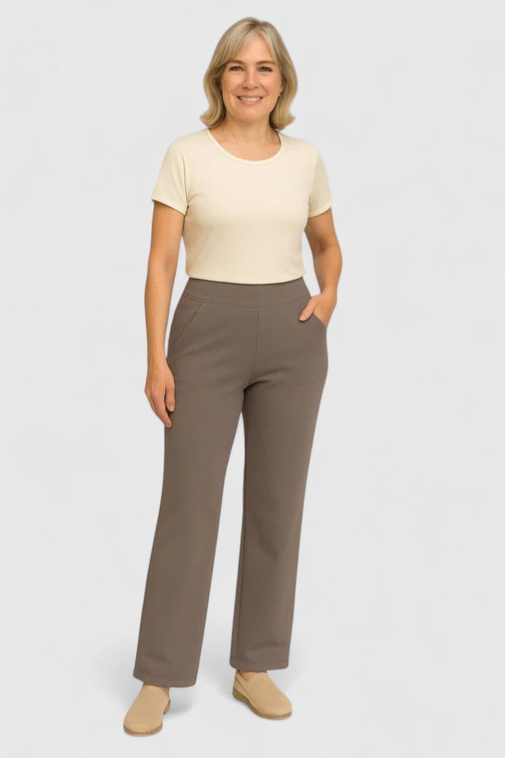 Woman wearing pull-on pants with a soft blouse, relaxed and comfortable at home.